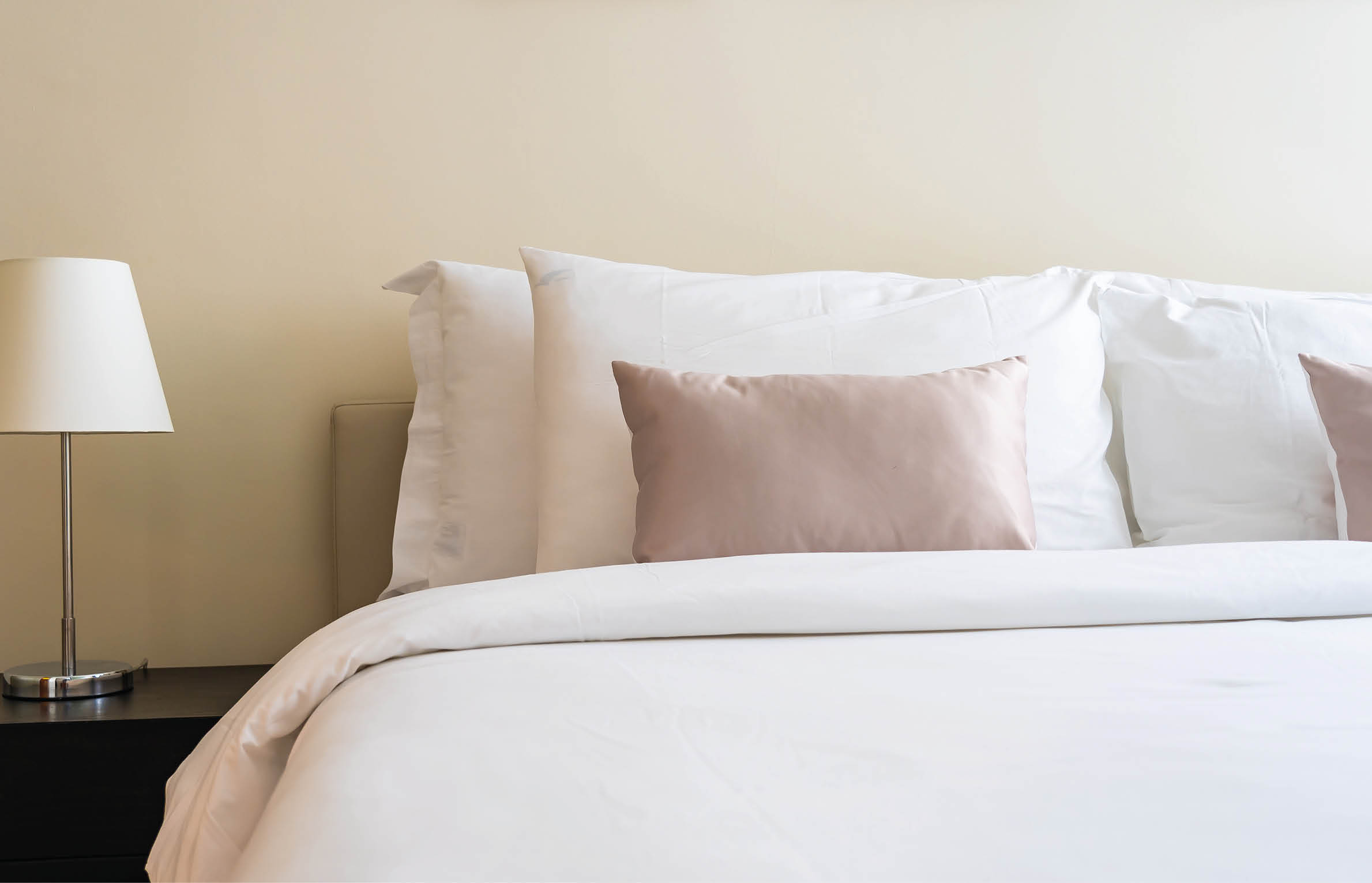 White comfortable pillow on bed decoration interior of bedroom