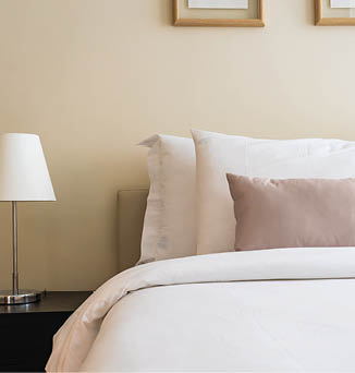 White comfortable pillow on bed decoration interior of bedroom